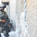Pfc. Jeremy C. Ramirez pulls security outside of a house in Tall Afar