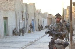 Pfc. Michael Fairburn gazes across the street as his platoon came to a halt