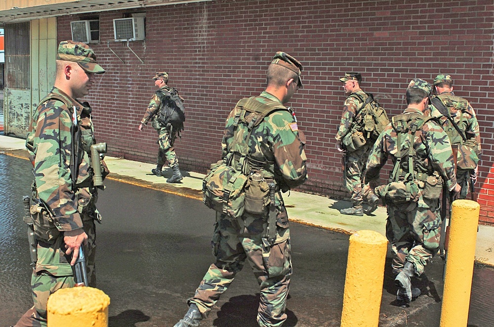 Soldiers make their way around one of the many washed out areas in a North