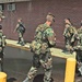 Soldiers make their way around one of the many washed out areas in a North