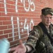 Sgt. Michael White tosses a can of spray paint back to another Soldier afte