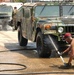 Paratroopers spray vehicles with hot-soapy water