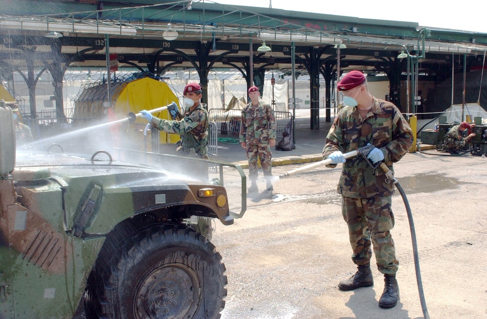 Spc. Cosino and Pvt. Ridgley spray down a humvee