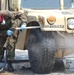 Pvt. Jerel Ridgley sprays down a humvee