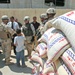 Iraqi Police and 2 BCT Soldiers hand out aid packages