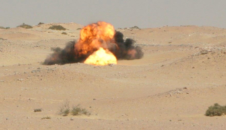 A fireball erupts from a detonating brick of Composition-Four