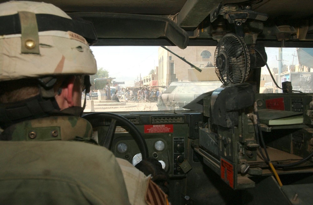 A Soldier drives through the city of Balad