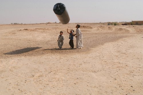 Iraqi children play with an inflatible toy