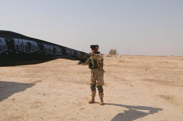 Sgt. Jason Gamble inflates a toy for Iraqi children