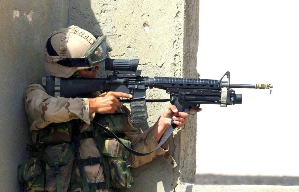 A Dutch soldier looks through his rifle scope