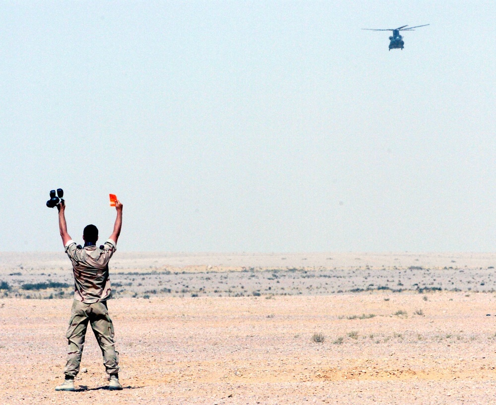 A member of The Dutch Royal Army guides in a CH-47 helicopter
