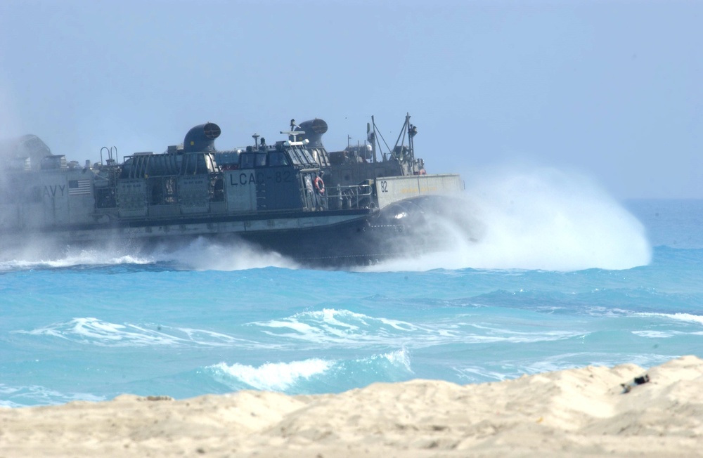 A U.S. Navy LCAC Vessel rushes onto shore
