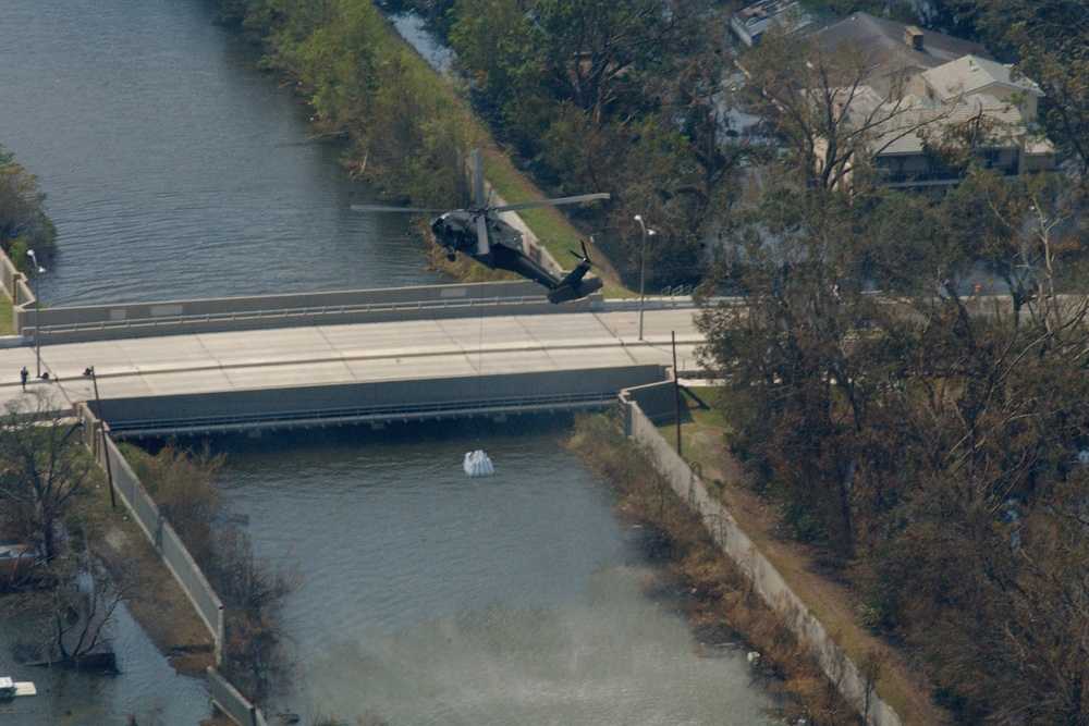 A UH 60 Blackhawk hovers above the 17th Street Canal
