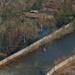 A UH 60 Blackhawk drops a sandbag into a hole in the levee