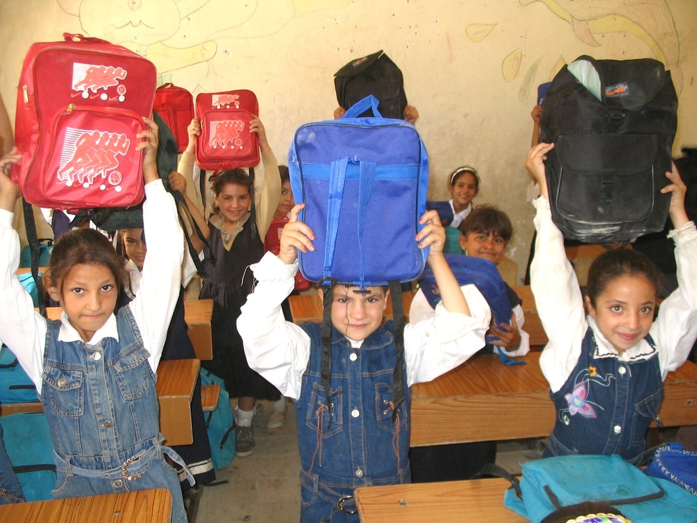 Children from the Gilgamish Primary Girls School show off their new backpac