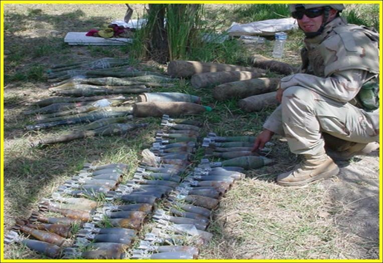 A Task Force Baghdad Soldier inventories the contents of a weapons cache