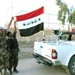 Public Order Brigade troopers proudly display the Iraqi flag