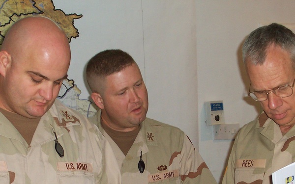 Maj. Gen. Raymond Rees Reviews a Document