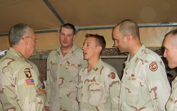 Maj. Gen. Raymond Rees talks with junior officers