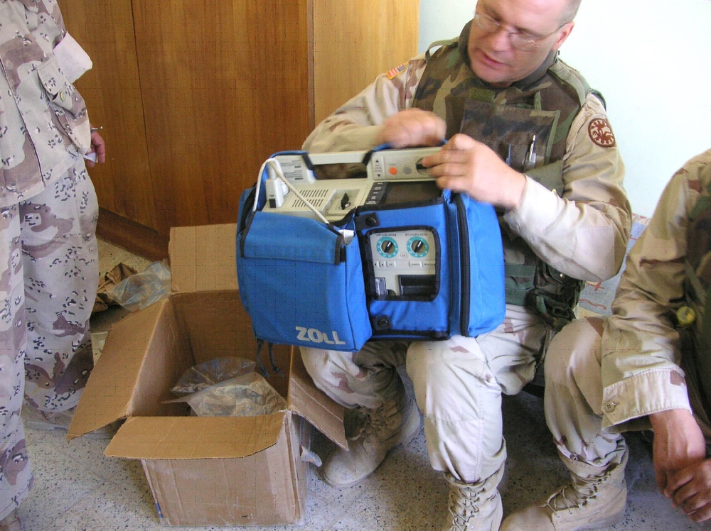 Staff Sgt. Dean Sowers unpacks a cardiac defibulator and electrocardiogram