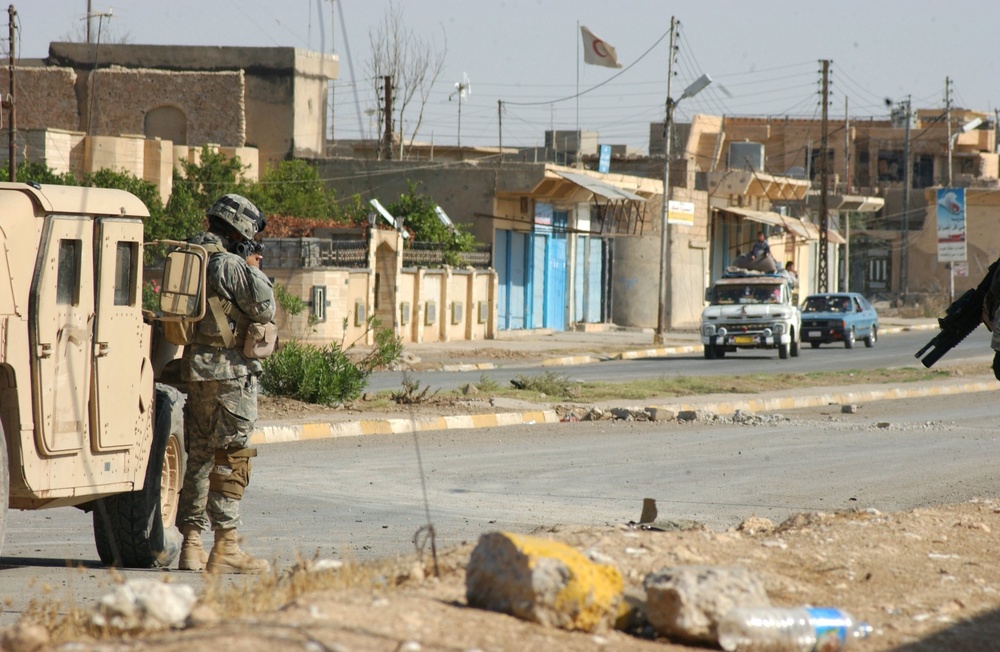 Paratroopers block off a street in Tall Afar