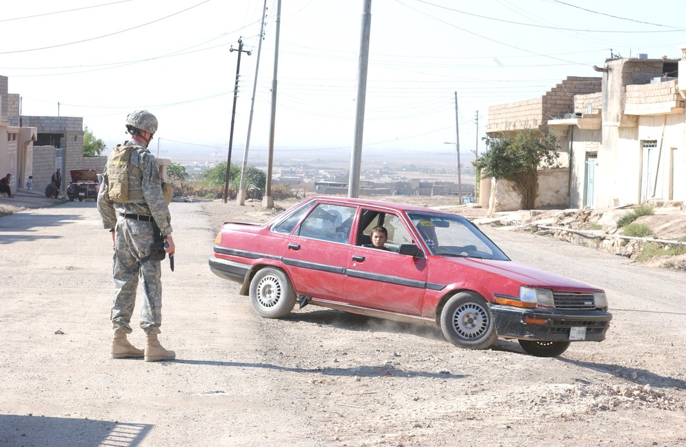 Sgt. Bret W. Dameworth forces a car to turn around