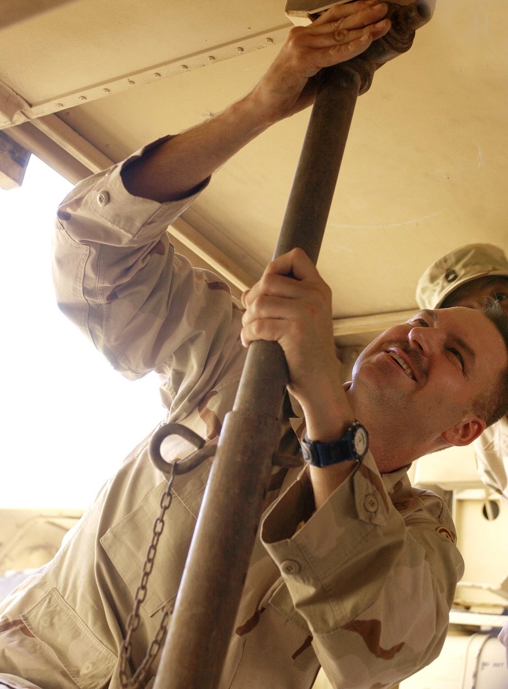 Major Tim Bennett Attaches a Support Element on the Bottom of One of the EE