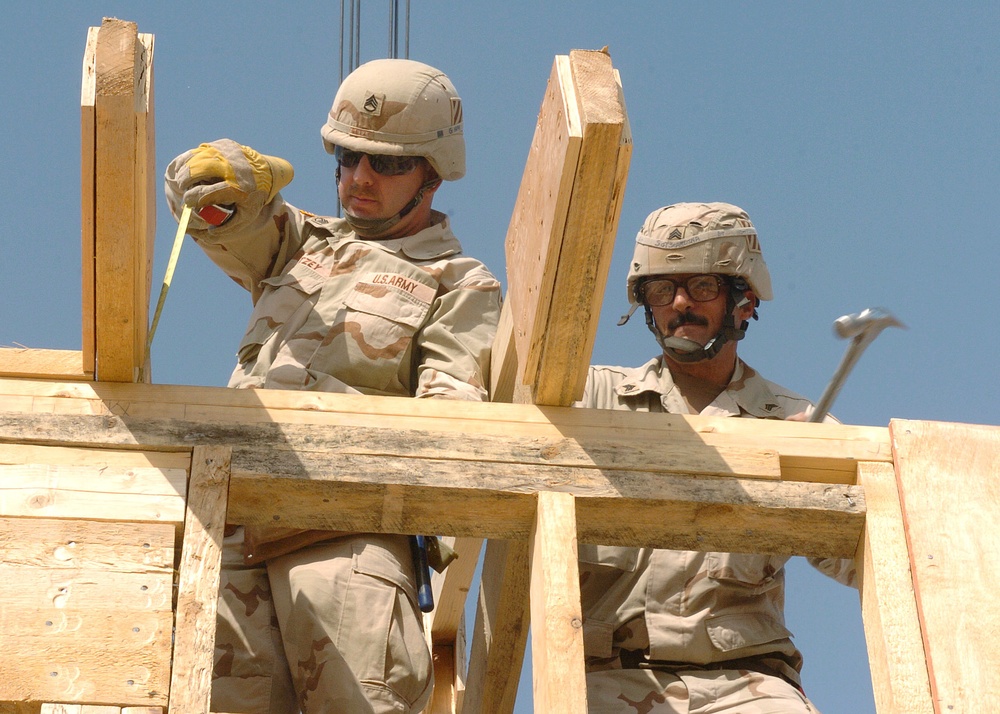 Soldiers put a truss in place