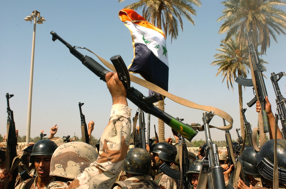 Soldiers raise their rifles in celebration