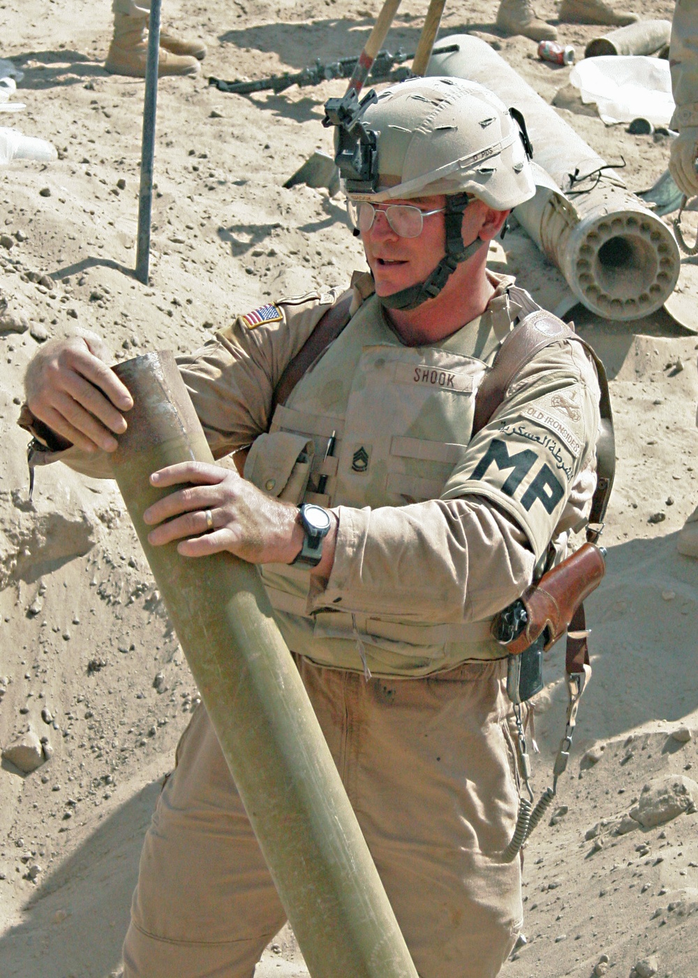 Sgt. 1st Class Shook removes a 122mm rocket tube from a weapons cache