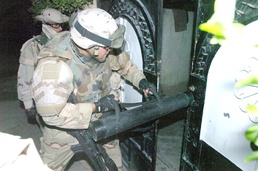 Spc. Gonzales smashes a gate open during a raid