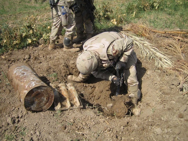 A Task Force Baghdad Soldier digs for more weapons