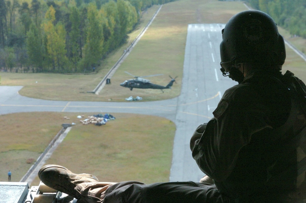 A U.S. Army Aircrew Member Sits in the Ramp of a CH-47