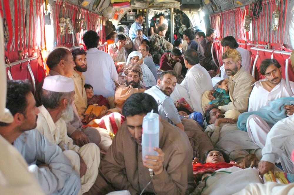 Injured Pakistani Civilians Sit on the Floor of a U.S. Army Ch-47