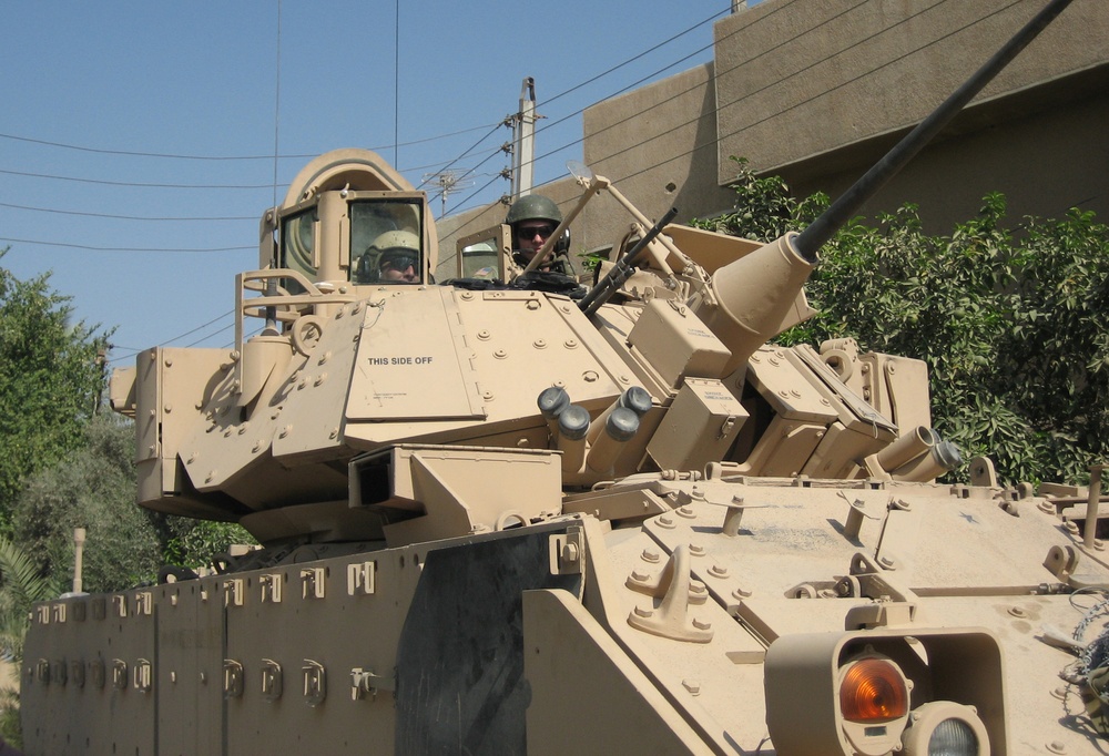 Soldiers stand guard in their M2 Bradley Fighting Vehicle