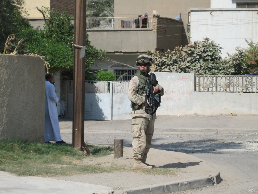 A Soldier remains vigilant on a street corner