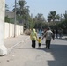 An Iraqi family walks toward a polling site