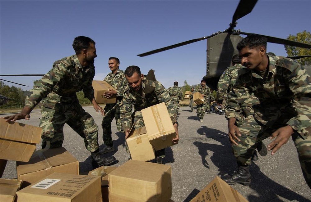 Pakistani soldiers hustle to unload U.S. medical supplies