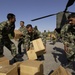 Pakistani soldiers hustle to unload U.S. medical supplies