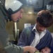 Petty Officer Wilkins comforts a Pakistani baby