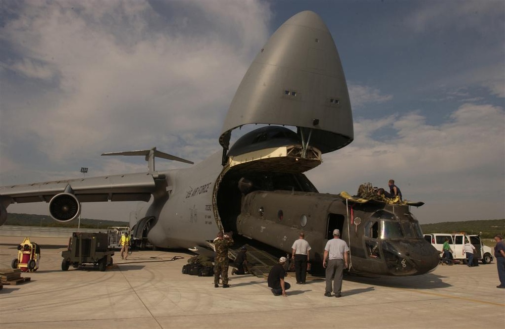 A CH-47 helicopter is loaded onto a C-5 Galaxy