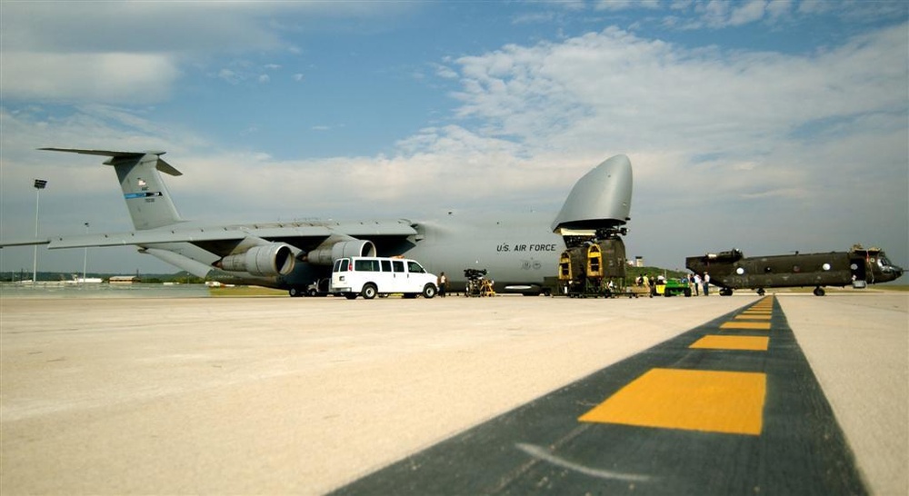 A CH-47 helicopter is loaded onto a C-5 Galaxy