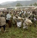 Pakistani soldiers try to control the crowd of local Pakistanis