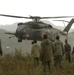 Pakistani soldiers watch as a U.S. Navy MH-53E Sea Dragon helicopter lands