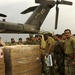 U.S. Navy Sailors and members of the Pakistan military load a MH-53E Sea Dr