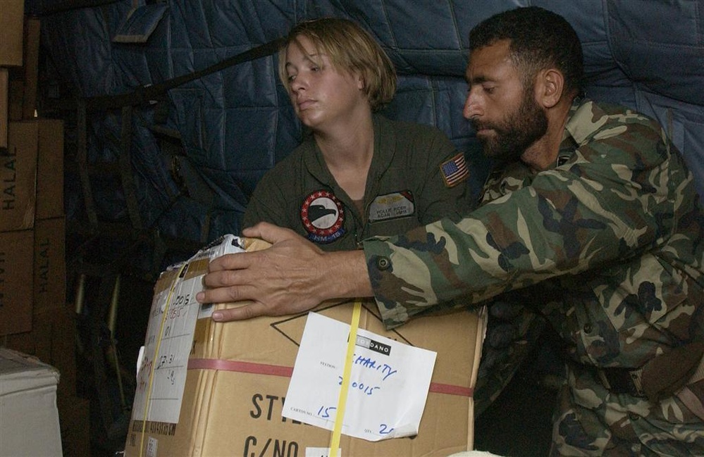 U.S. Navy Sailors and members of the Pakistan military load a MH-53E Sea Dr