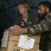 U.S. Navy Sailors and members of the Pakistan military load a MH-53E Sea Dr