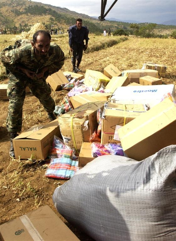 Members of the Pakistan military member off-load humanitarian supplies from