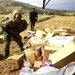 Members of the Pakistan military member off-load humanitarian supplies from