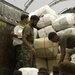 Members of the Pakistan military member load humanitarian supplies on to a